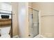 Bathroom features a shower with glass doors and updated fixtures at 6303 Trevor Simpson Dr, Indian Trail, NC 28079