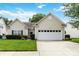 Charming single-story home featuring a well-manicured lawn and a two-car garage at 6303 Trevor Simpson Dr, Indian Trail, NC 28079