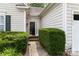The front entrance is framed by lush greenery, offering a welcoming appeal at 6303 Trevor Simpson Dr, Indian Trail, NC 28079