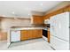 Well-lit kitchen features oak cabinets, white countertops, backsplash, and modern appliances at 6303 Trevor Simpson Dr, Indian Trail, NC 28079