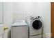 A laundry room features a washer, dryer, and wire shelving at 6303 Trevor Simpson Dr, Indian Trail, NC 28079