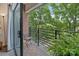 An inviting balcony offers outdoor seating and scenic views of lush green trees at 715 N Church St # 310, Charlotte, NC 28202