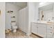 A bathroom featuring a white vanity, toilet, shower with curtain, and wood-look flooring at 715 N Church St # 310, Charlotte, NC 28202