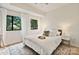 Serene bedroom with white bedding, two windows with outside views, and stylish side tables at 715 N Church St # 310, Charlotte, NC 28202
