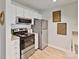Modern kitchen equipped with stainless steel appliances, white cabinets, and light wood floors at 715 N Church St # 310, Charlotte, NC 28202