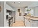 Well-lit kitchen showcasing stainless steel appliances, ample counter space, and modern cabinetry at 715 N Church St # 310, Charlotte, NC 28202