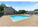 Community pool surrounded by lounge chairs and lush landscaping at 715 N Church St # 310, Charlotte, NC 28202