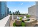 Outdoor rooftop space with modern seating, vibrant green accents, and a panoramic city view at 715 N Church St # 310, Charlotte, NC 28202