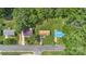 An aerial view displays three homes with vibrant roofs surrounded by lush green lawns and mature trees at 798 Wilson St, China Grove, NC 28023