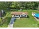 Aerial view of home and yard with a driveway and additional blue covered parking space at 798 Wilson St, China Grove, NC 28023