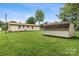 Large yard with green grass and storage shed, exterior view of ranch style home at 798 Wilson St, China Grove, NC 28023