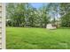 Large back yard with green grass and multiple storage buildings at 798 Wilson St, China Grove, NC 28023
