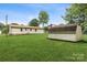 Large yard with green grass and storage shed, exterior view of ranch style home at 798 Wilson St, China Grove, NC 28023