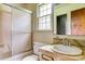 Bathroom with a shower, toilet, sink, and window needs renovation and updating at 798 Wilson St, China Grove, NC 28023