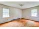 Bedroom with neutral walls, two windows, and dated carpet, needs modernization at 798 Wilson St, China Grove, NC 28023