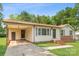 Single-story home featuring a convenient carport, light siding, and a brick foundation at 798 Wilson St, China Grove, NC 28023