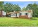 Single-story home featuring brick accents, light siding, and a well-kept front lawn at 798 Wilson St, China Grove, NC 28023
