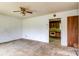 Empty living room, featuring a ceiling fan, and an open view of the kitchen at 798 Wilson St, China Grove, NC 28023