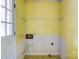 Unfinished room featuring yellow walls, an electrical box, and outdated flooring at 798 Wilson St, China Grove, NC 28023