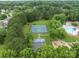 Aerial view of community tennis courts and playground at 8906 Pickering Grove Ln, Charlotte, NC 28216