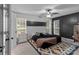 Stylish bedroom with a dark accent wall, a ceiling fan, and a patterned rug at 8906 Pickering Grove Ln, Charlotte, NC 28216