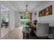 Dining area with modern light fixture, stylish dining table, and access to the outdoor patio at 8906 Pickering Grove Ln, Charlotte, NC 28216