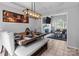 Open-concept dining area with stylish table setting, modern lighting, and views into the living room at 8906 Pickering Grove Ln, Charlotte, NC 28216