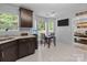 Bright kitchen area featuring dark wood cabinets, a breakfast nook, and a view of the backyard at 8906 Pickering Grove Ln, Charlotte, NC 28216