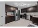 Well-equipped kitchen featuring stainless steel appliances, dark wood cabinets, and ample counter space at 8906 Pickering Grove Ln, Charlotte, NC 28216