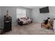 Relaxing living room with neutral carpet, a comfortable futon, and a stylish accent chair at 8906 Pickering Grove Ln, Charlotte, NC 28216