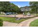Community playground with multiple play structures and benches at 8906 Pickering Grove Ln, Charlotte, NC 28216