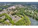 Aerial view of a neighborhood with homes, mature trees, and access to the lake at 104 Edgewater Park St, Davidson, NC 28036