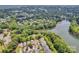 Aerial view of a neighborhood near the lake covered in mature trees at 104 Edgewater Park St, Davidson, NC 28036