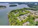 Aerial view of waterfront community with lush green trees and blue water at 104 Edgewater Park St, Davidson, NC 28036