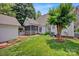 Lush backyard with a well-maintained lawn and manicured landscaping at 104 Edgewater Park St, Davidson, NC 28036