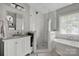 Contemporary bathroom featuring a glass shower, soaking tub, and stylish fixtures at 104 Edgewater Park St, Davidson, NC 28036