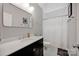 Well-lit bathroom featuring a large mirror, vanity, and shower with curtain at 104 Edgewater Park St, Davidson, NC 28036