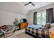 Inviting bedroom with a unique chair, plaid bedding, and dresser at 104 Edgewater Park St, Davidson, NC 28036