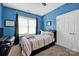 Bright blue bedroom featuring a comfortable bed with decorative pillows at 104 Edgewater Park St, Davidson, NC 28036