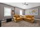 Spacious bonus room with a large sectional couch and natural light at 104 Edgewater Park St, Davidson, NC 28036