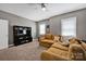 Bonus room with sectional, TV, bookcase and plentiful light at 104 Edgewater Park St, Davidson, NC 28036