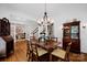 Elegant dining room featuring hardwood floors, classic chandelier, and access to the office and hall at 104 Edgewater Park St, Davidson, NC 28036