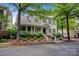 Lovely home featuring a cozy front porch, brick-lined stairs, and lush landscaping, offering great curb appeal at 104 Edgewater Park St, Davidson, NC 28036