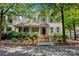 Charming home featuring a welcoming front porch, landscaped garden, and classic architectural details at 104 Edgewater Park St, Davidson, NC 28036