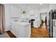 Bright white kitchen with stainless steel appliances, and hardwood floors at 104 Edgewater Park St, Davidson, NC 28036