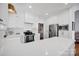 Bright white kitchen featuring stainless steel appliances, quartz counters, and a breakfast bar at 104 Edgewater Park St, Davidson, NC 28036