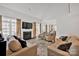Spacious living room with a fireplace, large windows, hardwood floors, and neutral-toned furniture at 104 Edgewater Park St, Davidson, NC 28036