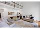 Open living room featuring high ceilings, hardwood floors, and neutral-toned furniture at 104 Edgewater Park St, Davidson, NC 28036