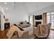 Spacious living room with a fireplace, large windows, hardwood floors, and neutral-toned furniture at 104 Edgewater Park St, Davidson, NC 28036