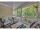 Relaxing covered porch with comfortable seating, perfect for enjoying the serene wooded view at 104 Edgewater Park St, Davidson, NC 28036